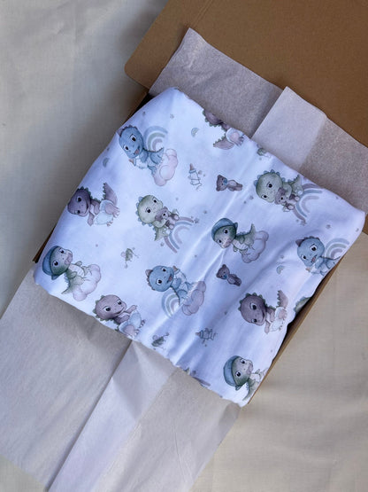 mussola di cotone bianco con dinosauri