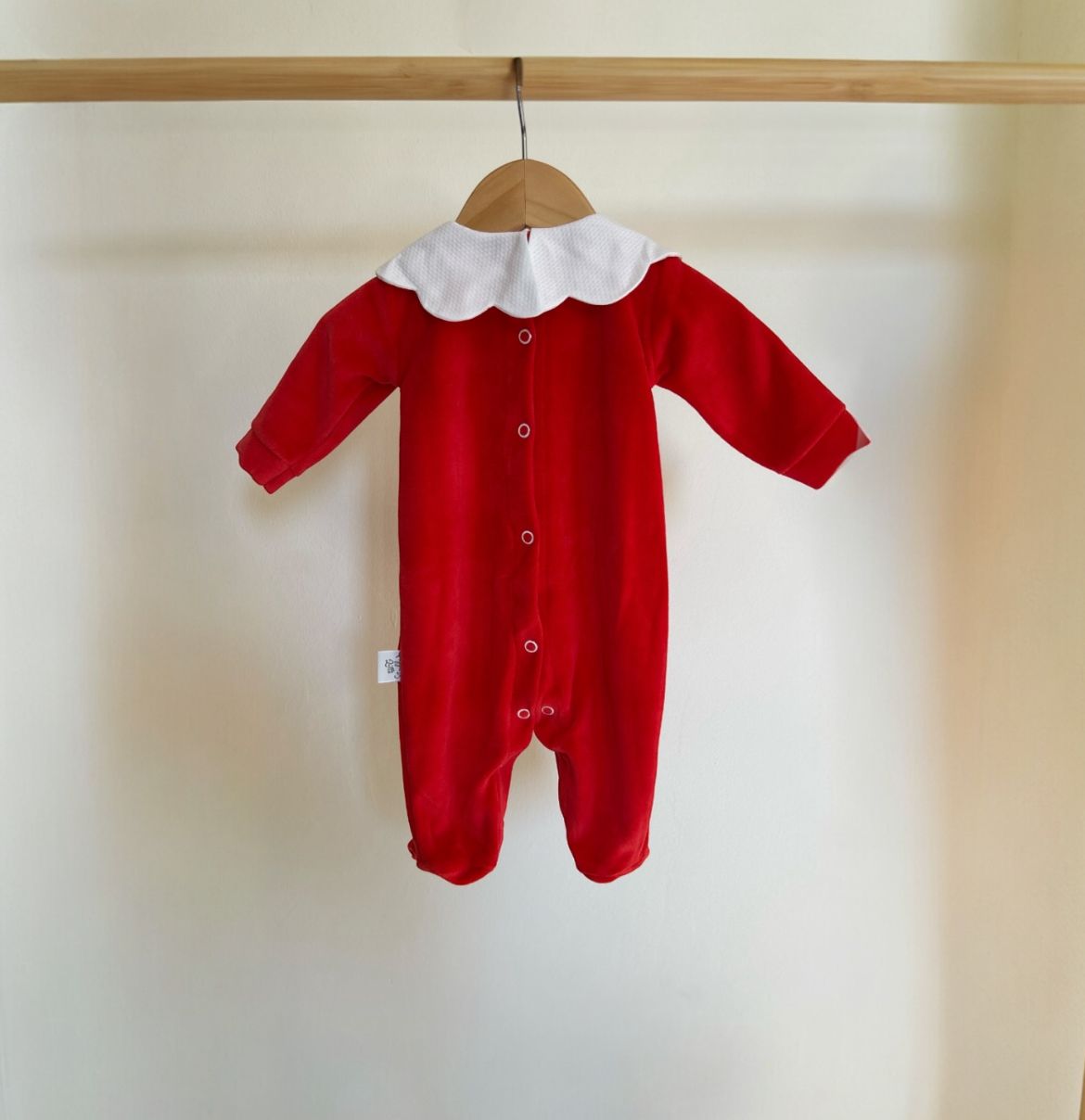 particolare dei bottoncini sul retro della tutina rossa in ciniglia